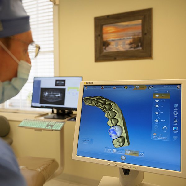 Dentist examining images captured with intraoral camera
