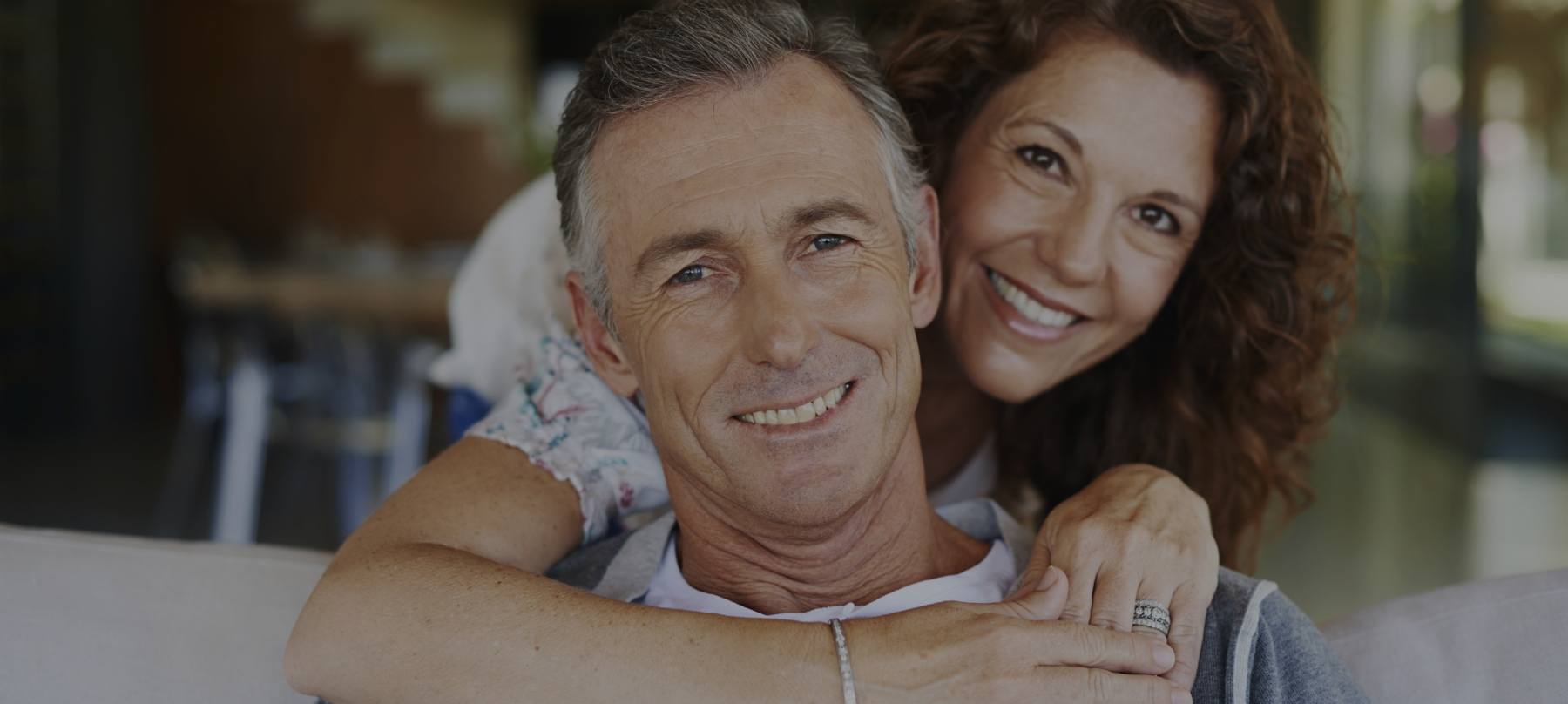 Man and woman with healthy smiles thanks to emergency dentistry