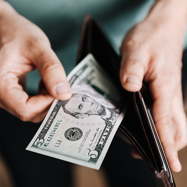 Man pulling cash out of wallet