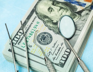 Dental instruments on $100 bills