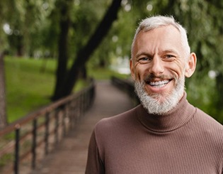 a man smiling with his dentures