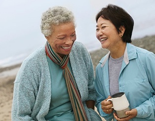 mature friends smiling and talking with each other