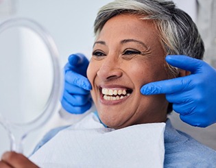 a patient smiling with her new dentures