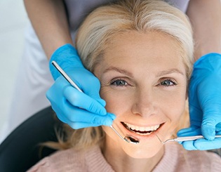 a patient smiling while getting her teeth checked