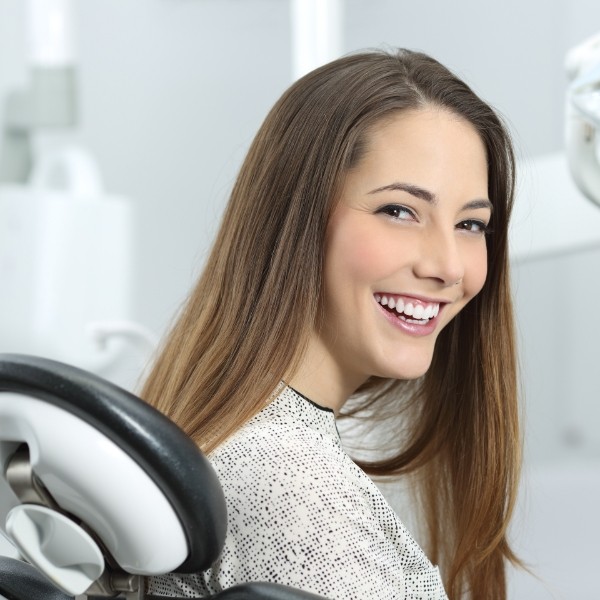 Woman smiling during dental checkup to preventive dental emergencies