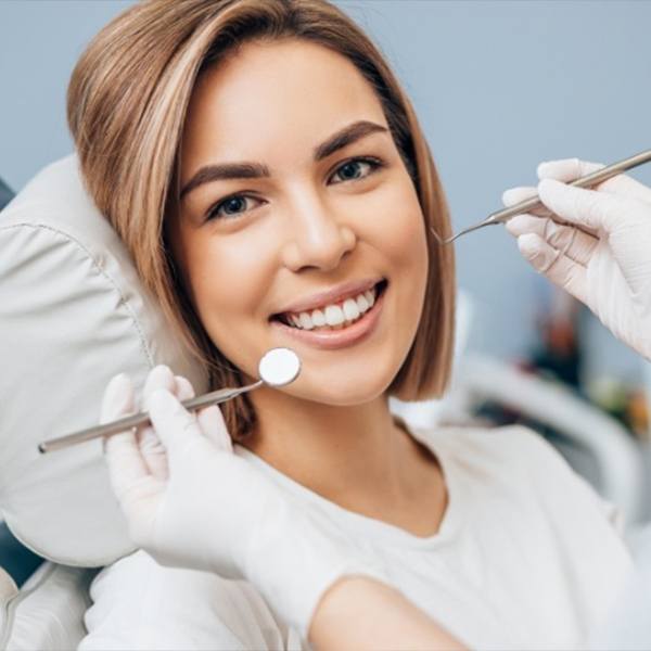 Patient receiving preventive dentistry checkup and teeth cleaning