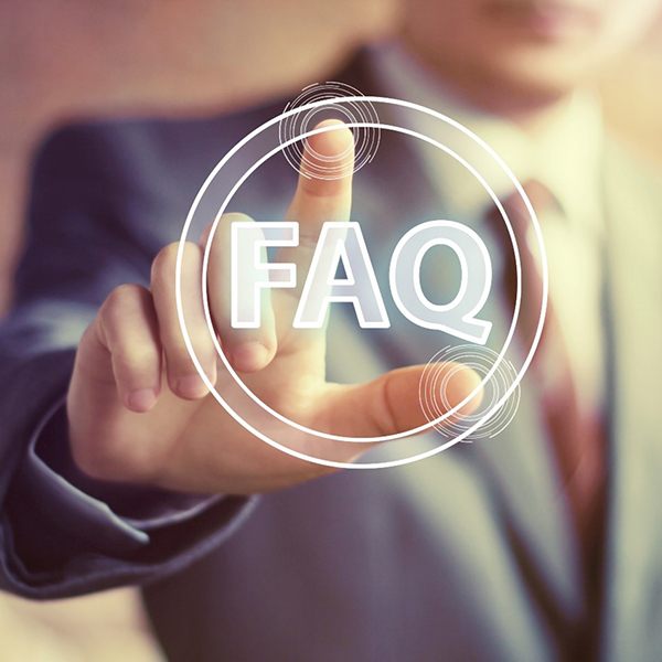 Business man pointing fingers at white FAQ graphic 