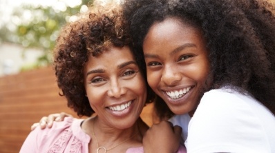 Mother and daughter smiling after children's dentistry visit