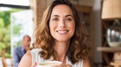 Woman with beautiful smile after replacing missing teeth with dental implants