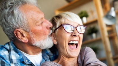 Man and woman with healthy smiles after gum disease treatment