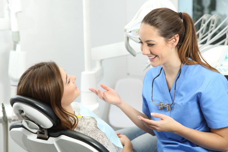 dentist speaking with dental implant candidate