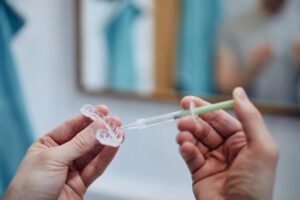 Person using a teeth whitening kit